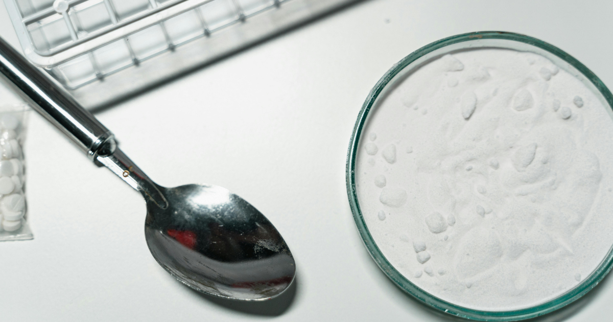 Cocaine intoxication management: White powder in petri dish, spoon, and pills, representing cocaine.