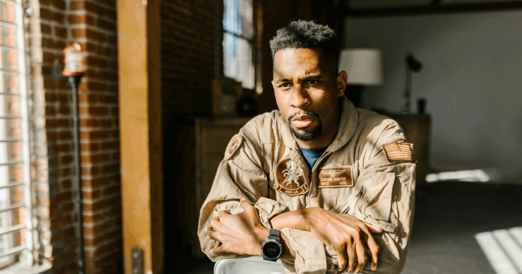 Grief Stages: Man in Flight Suit - Journey Through Grief - Los Angeles Mental Health Man in flight suit embodies grief stage. Journey Through the Five Stages of Grief concept. Shows emotion and introspection.