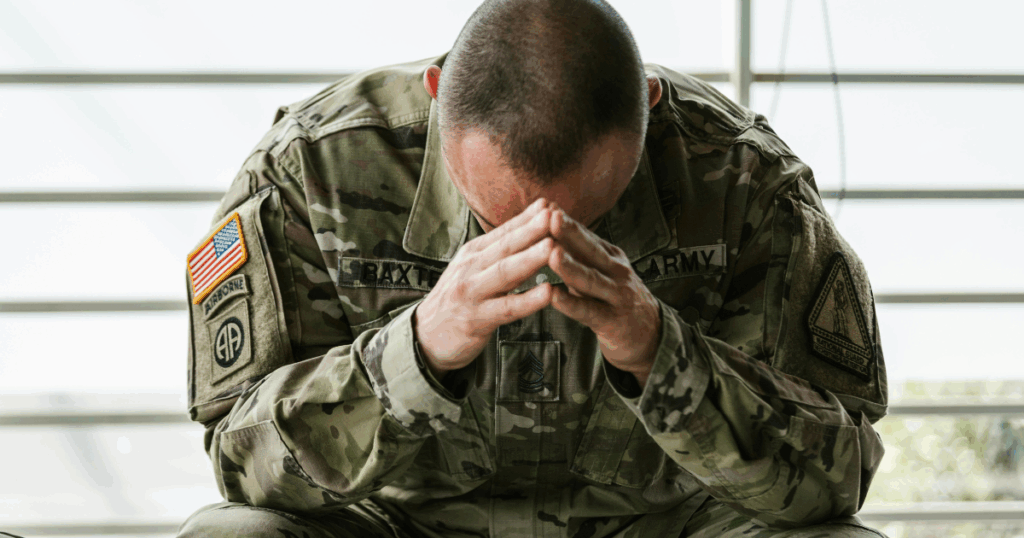 Grieving Soldier: Journey Through the Five Stages of Grief - Los Angeles Mental Health Grieving soldier in uniform, head in hands. Military grief and loss concept. Journey Through the Five Stages of Grief.